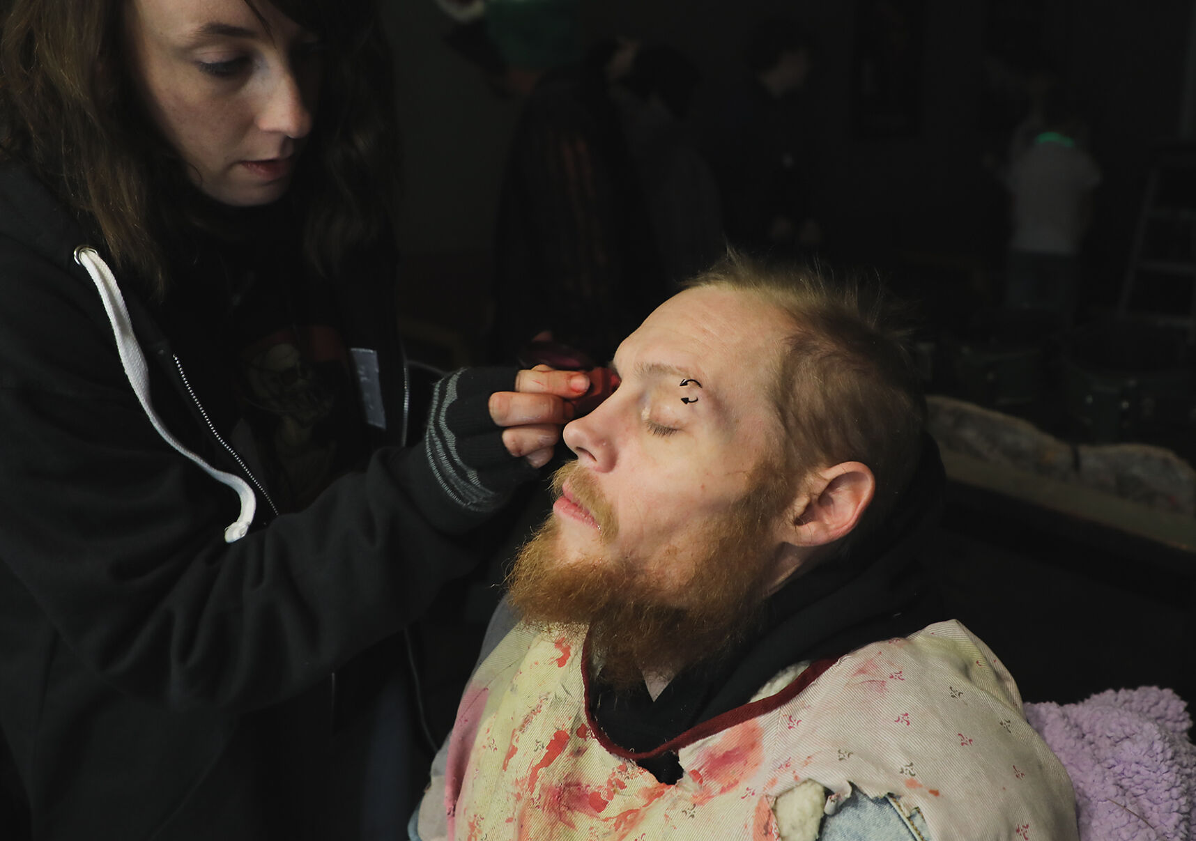 Ashley Monroe applies face paint to Allen Fisher before his performance